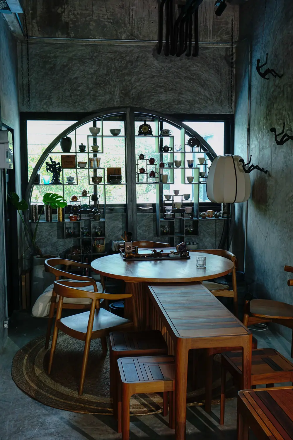 Round tea table by the arched window at Moychay Phuket