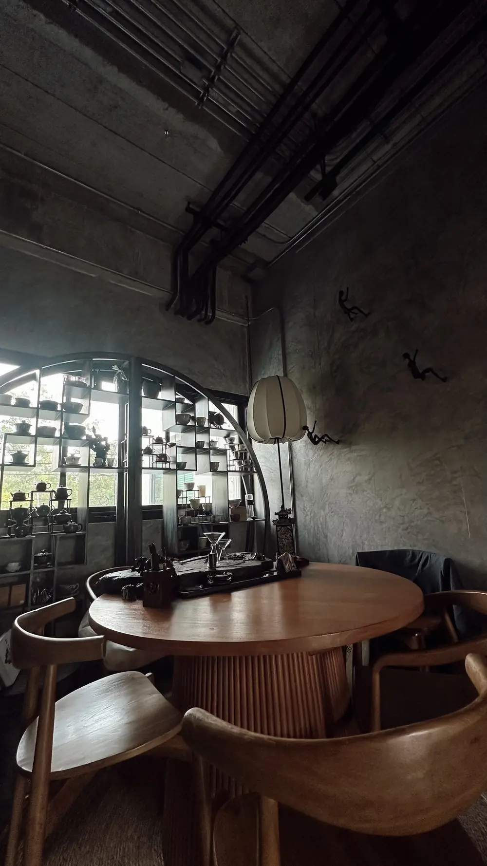 Tea table and wooden chairs by the arched window