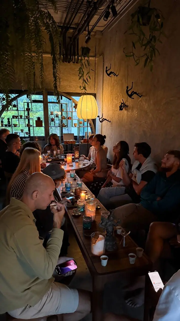 Guests at a tea evening around a long table at Moychay Phuket